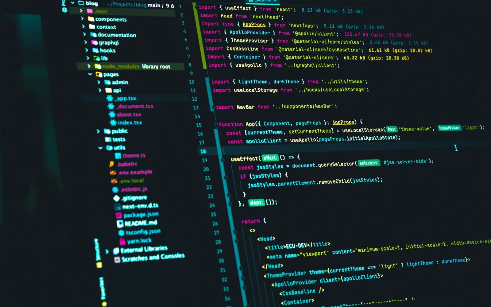 A monitor showing React code in a dark editor